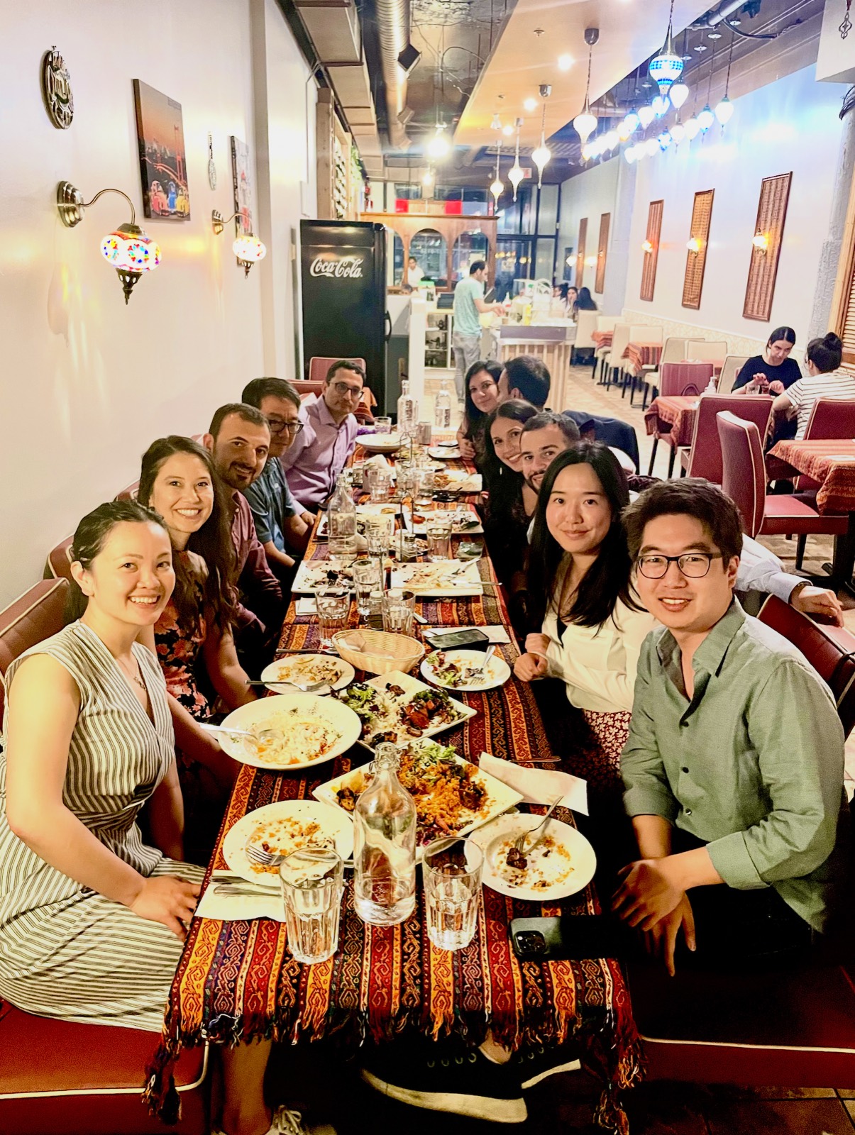 Lab members around a long table at a conference dinner